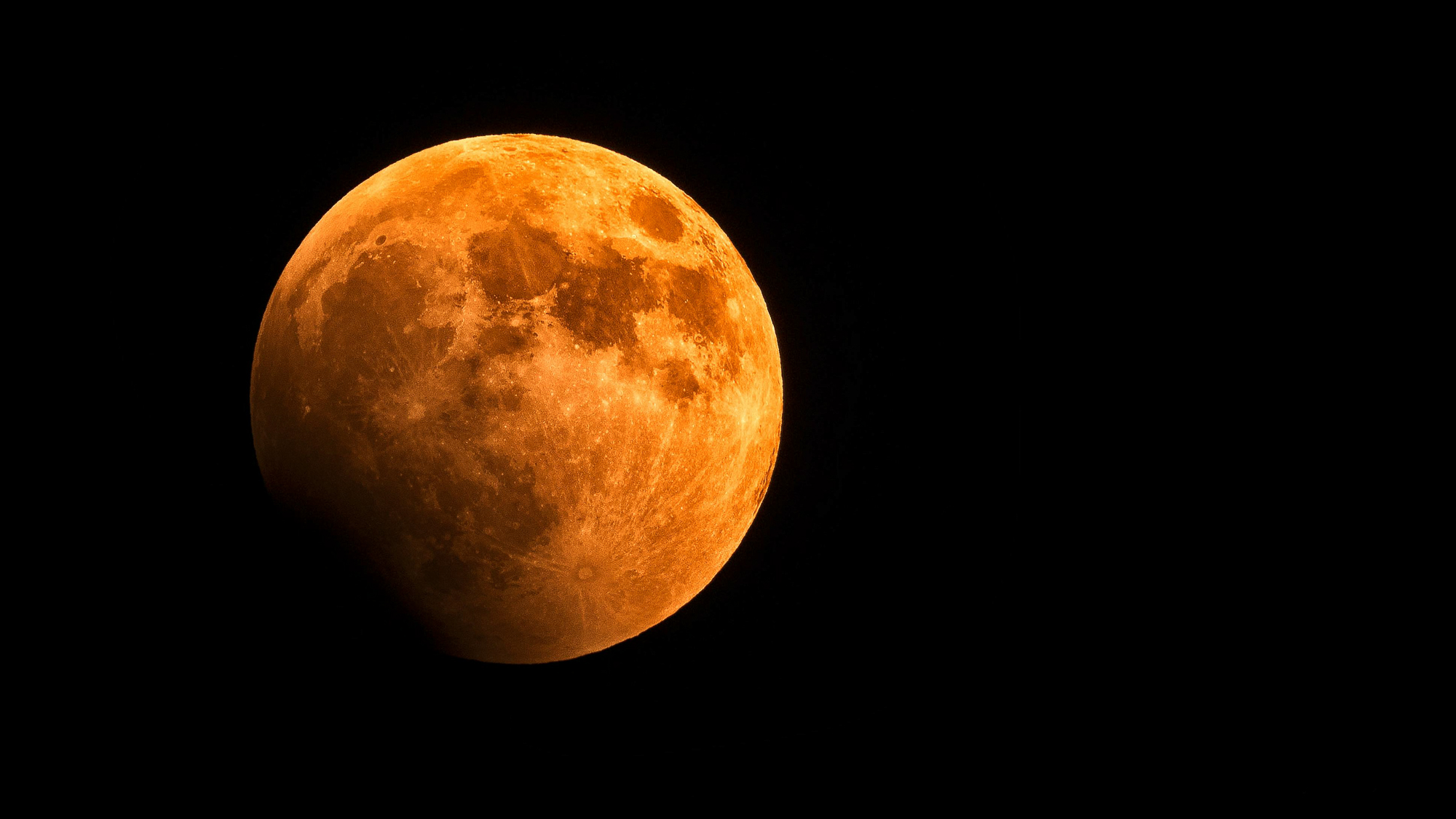Blood Moon during a lunar eclipse event in an inky black sky