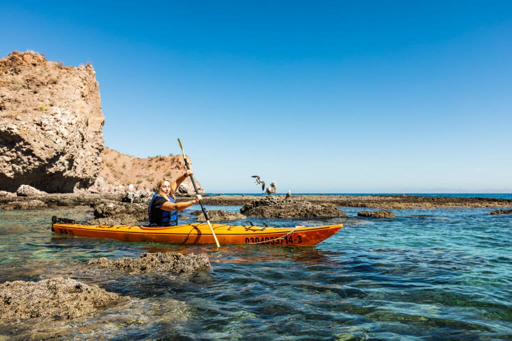 Best time to go to Baja for watersports. Guest enjoying canoeing in Baja.